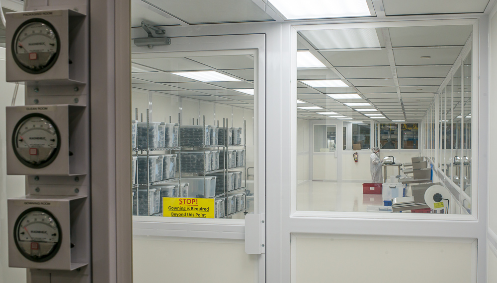 Employee working in a cleanroom environment.